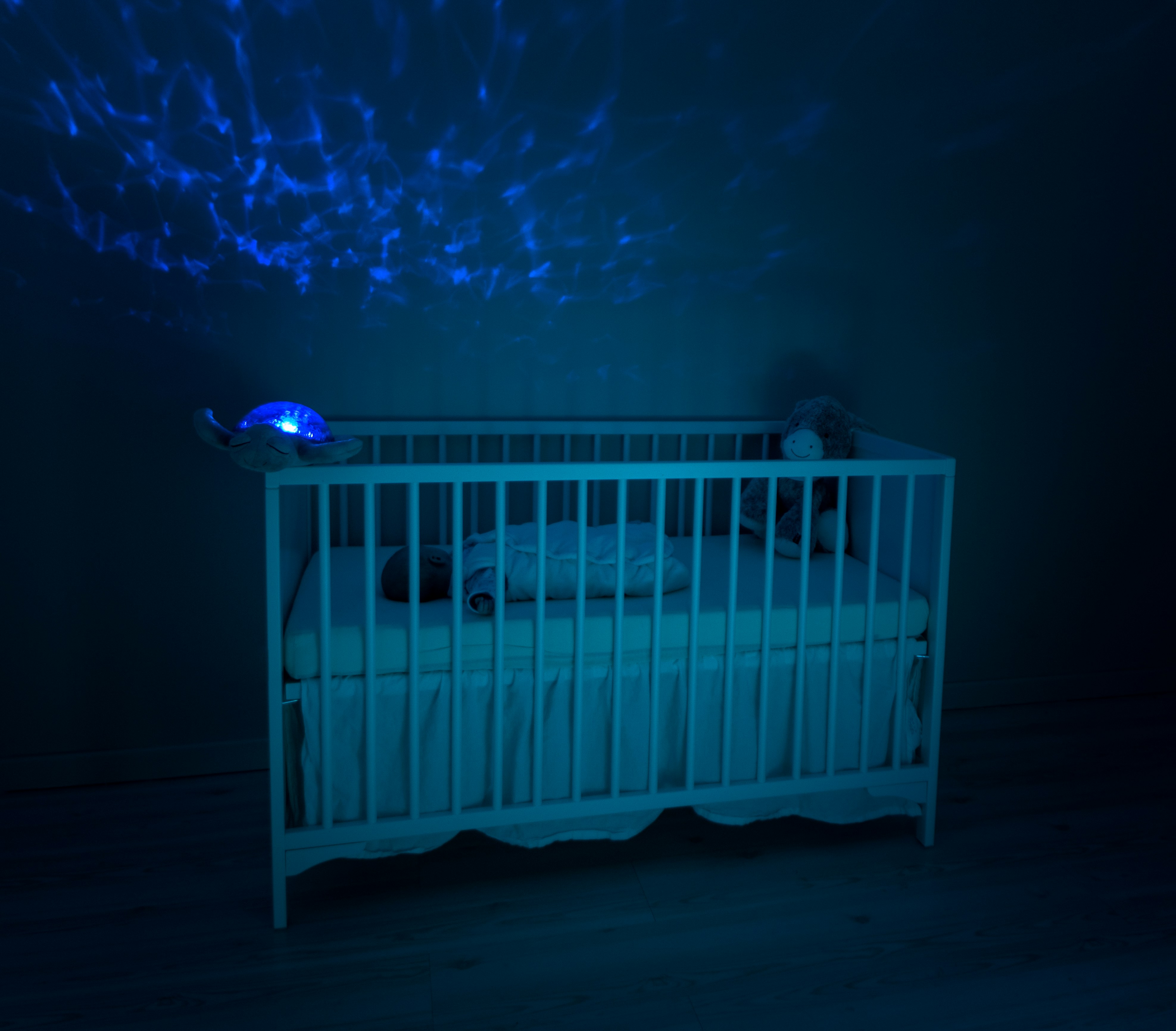 Baby sleeping peacefully through the night in dark room